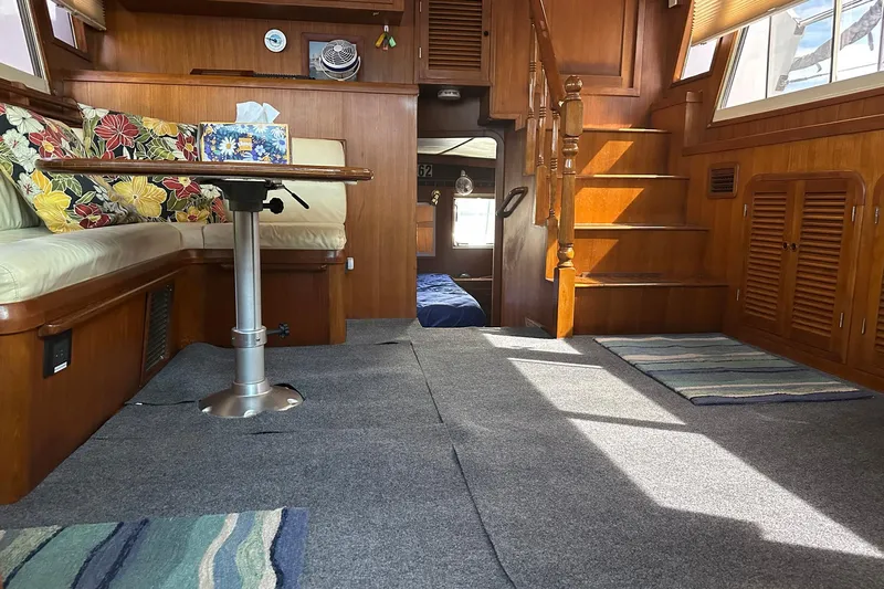 Off Ramp Yacht Photos Pics Luxurious 2002 Novatec Sundeck yacht interior with cozy seating and elegant wooden finishes.