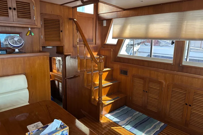 Off Ramp Yacht Photos Pics Interior of 2002 Novatec Sundeck yacht with wooden stairs and cabinetry.