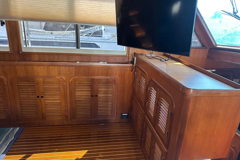 Off Ramp Yacht Photos Pics 2002 Novatec Sundeck interior with wooden cabinets and mounted TV.