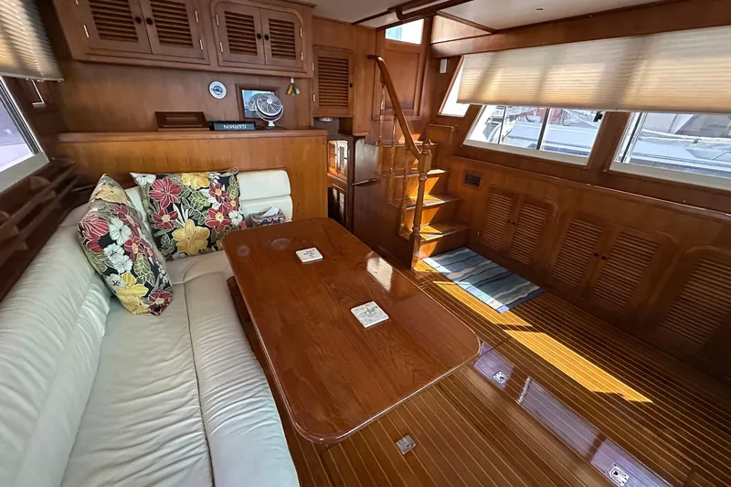 Off Ramp Yacht Photos Pics Luxurious 2002 Novatec Sundeck yacht interior with wooden decor and floral cushions.