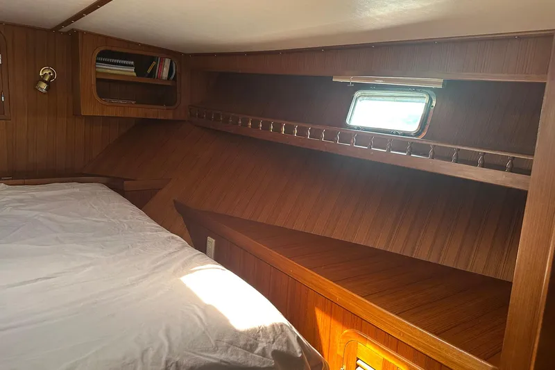 Off Ramp Yacht Photos Pics Cozy cabin interior of 2002 Novatec Sundeck yacht with wooden finish and small window.