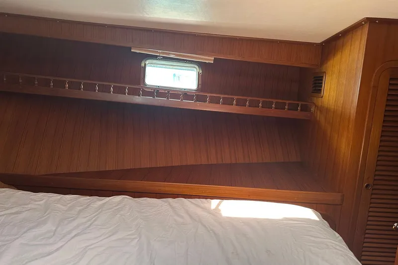 Off Ramp Yacht Photos Pics Cozy wooden interior of 2002 Novatec Sundeck yacht cabin with window and bed.