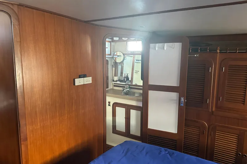 Off Ramp Yacht Photos Pics Interior of 2002 Novatec Sundeck yacht with wooden cabinetry and bathroom view.