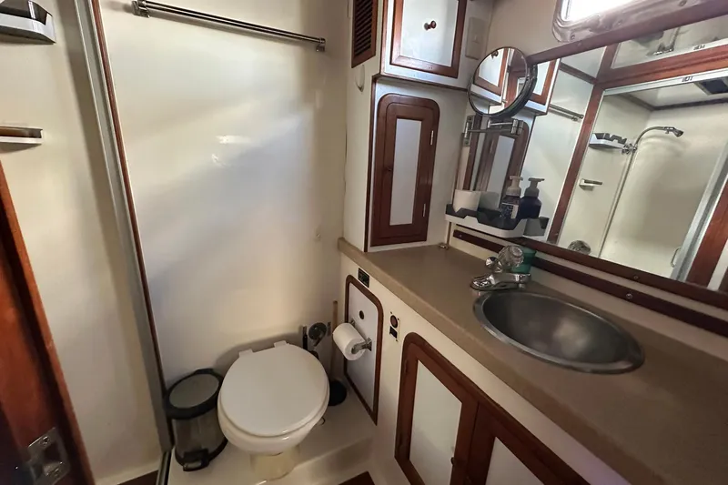 Off Ramp Yacht Photos Pics Bathroom interior of 2002 Novatec Sundeck yacht with sink, toilet, and mirror.