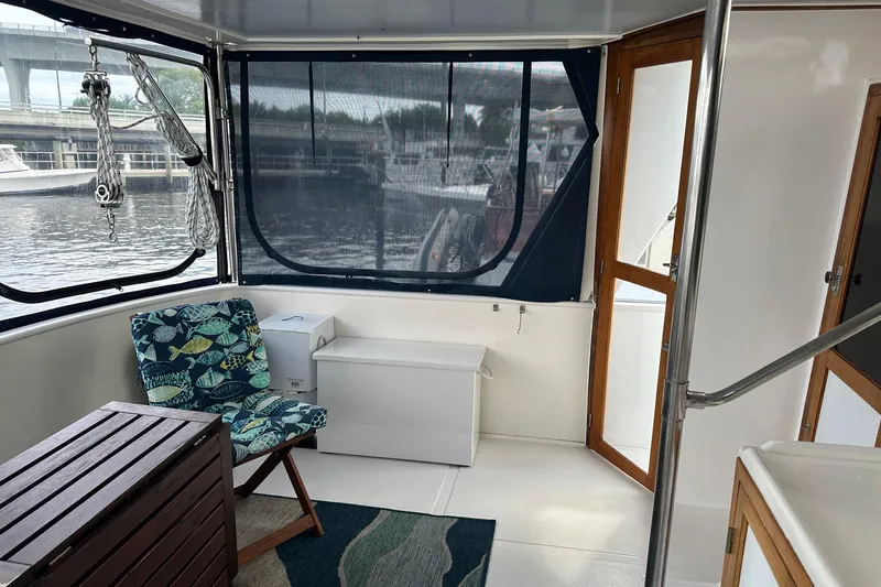 Off Ramp Yacht Photos Pics 2002 Novatec Sundeck interior with seating, wooden accents, and marina view.