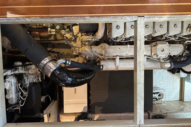 Off Ramp Yacht Photos Pics Engine compartment of a 2002 Novatec Sundeck yacht, showcasing mechanical components and piping.