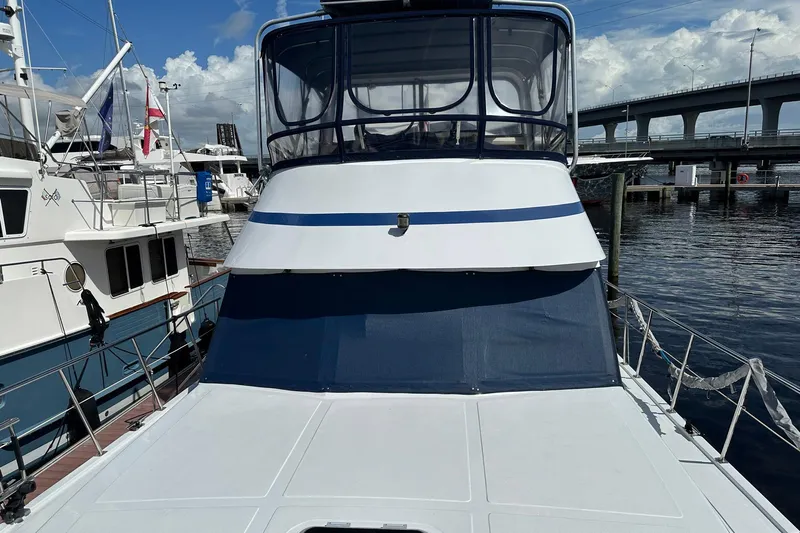 Off Ramp Yacht Photos Pics 2002 Novatec Sundeck yacht docked at marina, featuring spacious deck and enclosed helm.