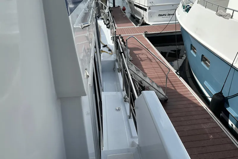 Off Ramp Yacht Photos Pics 2002 Novatec Sundeck yacht docked, showcasing side deck and marina view.