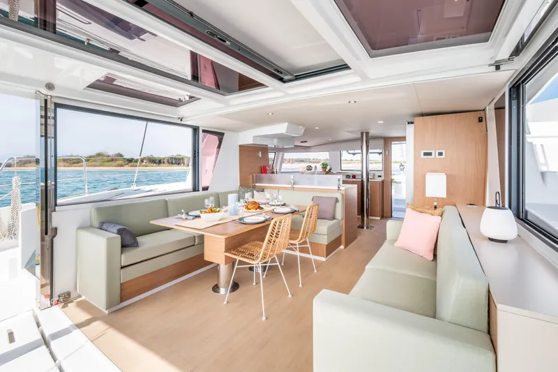  Yacht Photos Pics Luxurious interior of 2026 Bali 4.6 catamaran with modern dining area and scenic ocean view.