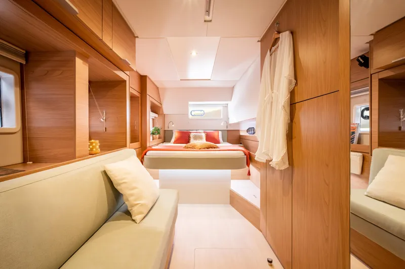  Yacht Photos Pics Luxurious interior of 2026 Bali 4.6 yacht with cozy bedroom and elegant wood finish.