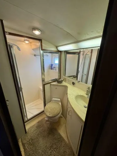 Hook 'em Yacht Photos Pics Bathroom interior of 1989 Hatteras 42 Convertible yacht, featuring shower and vanity.