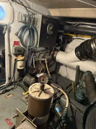 Hook 'em Yacht Photos Pics Engine room of 1989 Hatteras 42 Convertible boat with various mechanical components.