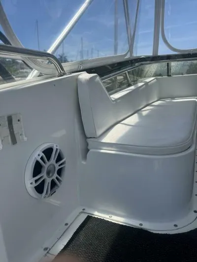 Hook 'em Yacht Photos Pics Interior of 1989 Hatteras 42 Convertible yacht with white seating and speaker.