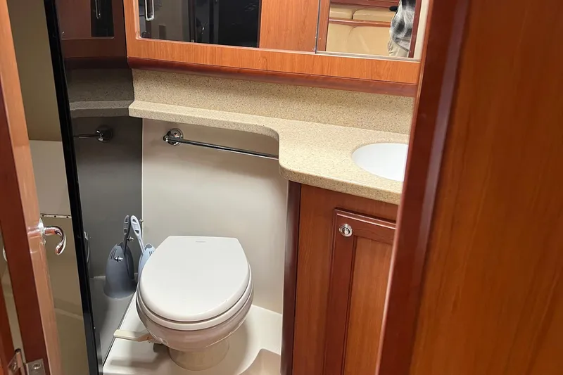 Reel Obsession Yacht Photos Pics 2007 Luhrs 41 Hardtop yacht bathroom with wooden cabinetry and modern fixtures.