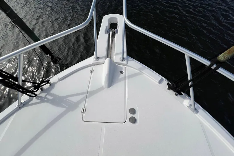 Reel Obsession Yacht Photos Pics Bow of 2007 Luhrs 41 Hardtop boat with anchor and railing, over water.