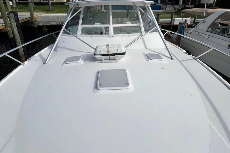 Reel Obsession Yacht Photos Pics 2007 Luhrs 41 Hardtop boat deck with hatches and railing, docked at marina.