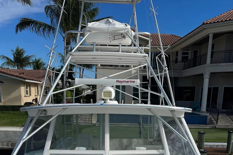 Reel Obsession Yacht Photos Pics 2007 Luhrs 41 Hardtop boat with Raymarine equipment, docked near luxury homes.
