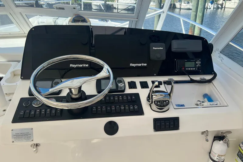 Reel Obsession Yacht Photos Pics 2007 Luhrs 41 Hardtop helm with Raymarine electronics and steering wheel.