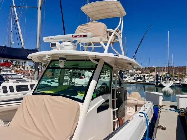 Sea SeÑor Yacht Photos Pics 2017 Boston Whaler 370 Outrage docked at marina under clear blue sky.