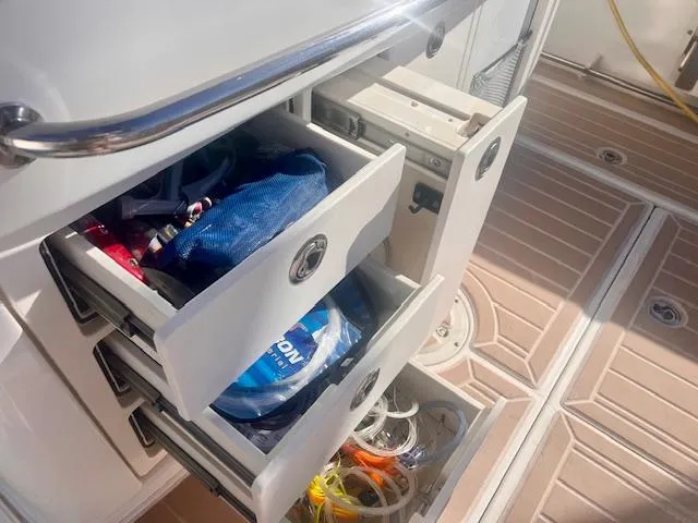 Sea SeÑor Yacht Photos Pics Storage drawers on a 2017 Boston Whaler 370 Outrage boat, filled with boating accessories.