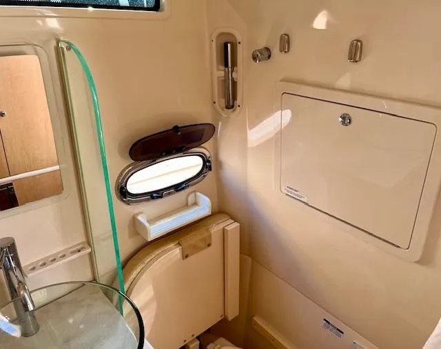 Sea SeÑor Yacht Photos Pics Interior of 2017 Boston Whaler 370 Outrage boat, featuring a compact bathroom with a porthole window.