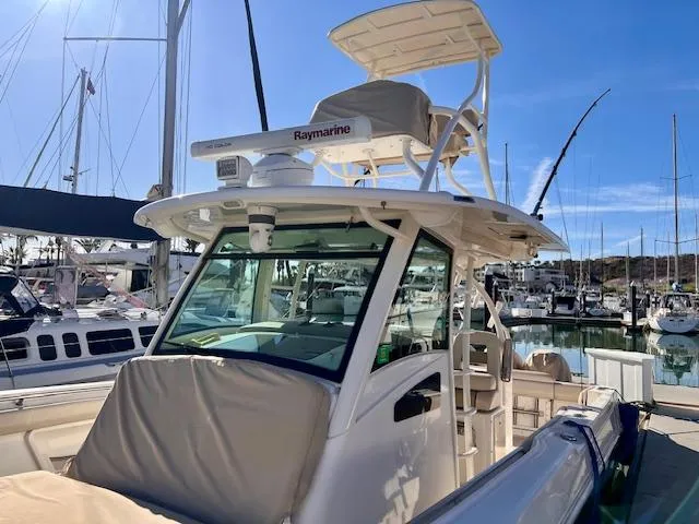 Sea SeÑor Yacht Photos Pics 2017 Boston Whaler 370 Outrage boat docked in marina under clear blue sky.