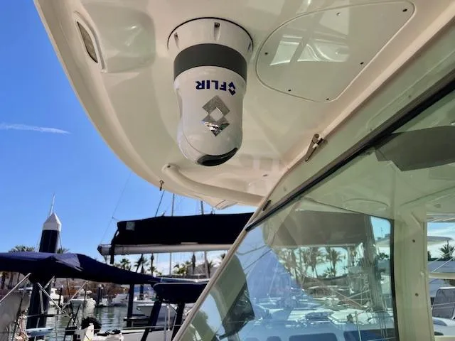 Sea SeÑor Yacht Photos Pics 2017 Boston Whaler 370 Outrage with FLIR camera, docked at marina under clear blue sky.