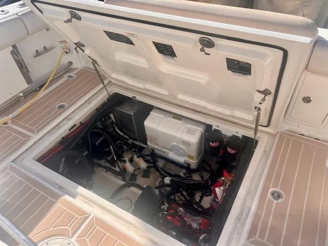 Sea SeÑor Yacht Photos Pics 2017 Boston Whaler 370 Outrage engine compartment with open hatch, showcasing internal components.