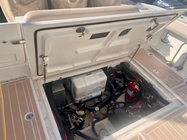 Sea SeÑor Yacht Photos Pics Open engine compartment of a 2017 Boston Whaler 370 Outrage boat, showing internal components.