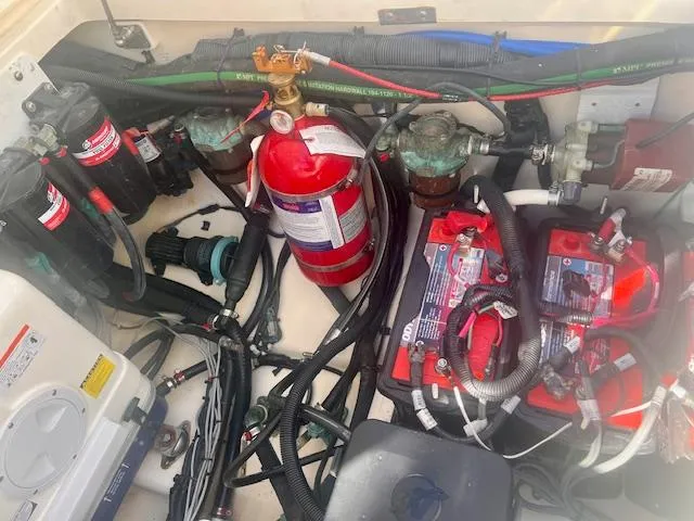 Sea SeÑor Yacht Photos Pics Engine compartment of a 2017 Boston Whaler 370 Outrage with fire extinguisher and batteries.
