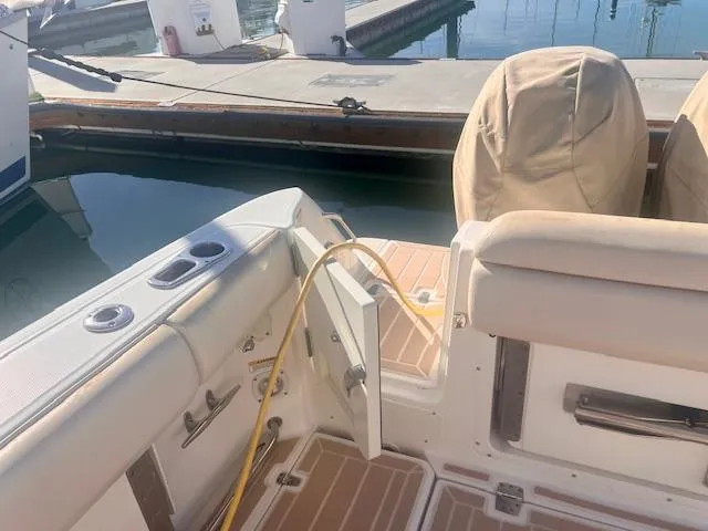 Sea SeÑor Yacht Photos Pics 2017 Boston Whaler 370 Outrage boat interior at dock, featuring seating and covered engines.