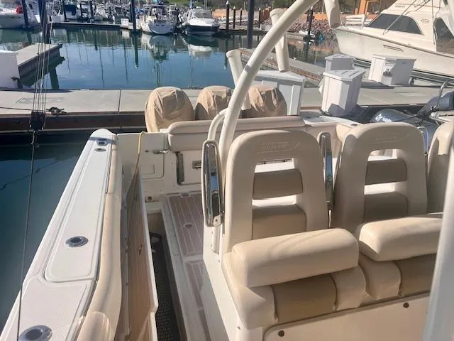 Sea SeÑor Yacht Photos Pics 2017 Boston Whaler 370 Outrage boat interior at marina, featuring cushioned seating and sleek design.