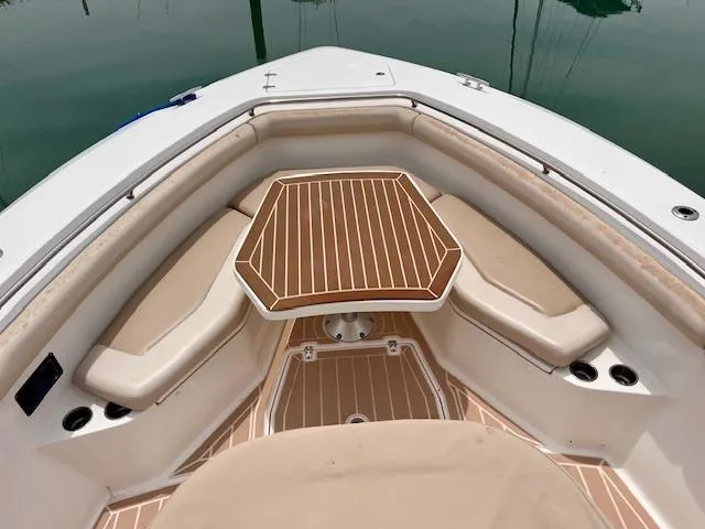 Sea SeÑor Yacht Photos Pics 2017 Boston Whaler 370 Outrage boat interior with cushioned seating and wooden table.