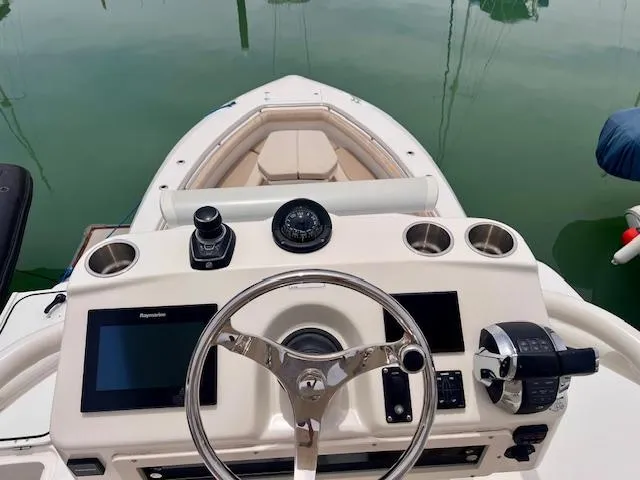 Sea SeÑor Yacht Photos Pics 2017 Boston Whaler 370 Outrage helm with steering wheel and navigation controls.