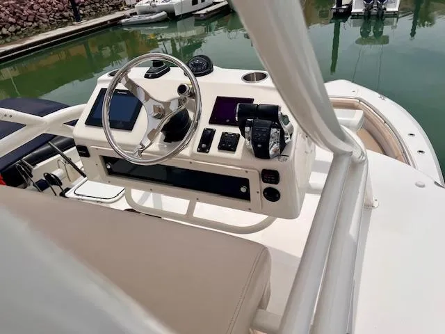Sea SeÑor Yacht Photos Pics 2017 Boston Whaler 370 Outrage helm with modern controls and navigation equipment.
