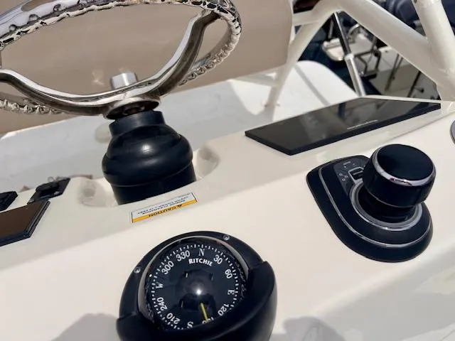 Sea SeÑor Yacht Photos Pics 2017 Boston Whaler 370 Outrage helm with compass and navigation controls.