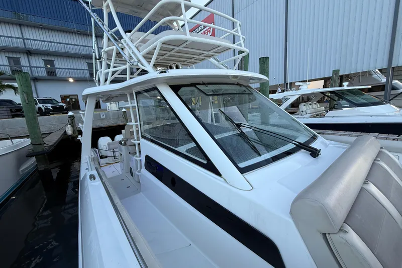  Yacht Photos Pics 2020 Boston Whaler 420 Outrage docked, showcasing sleek design and spacious deck.