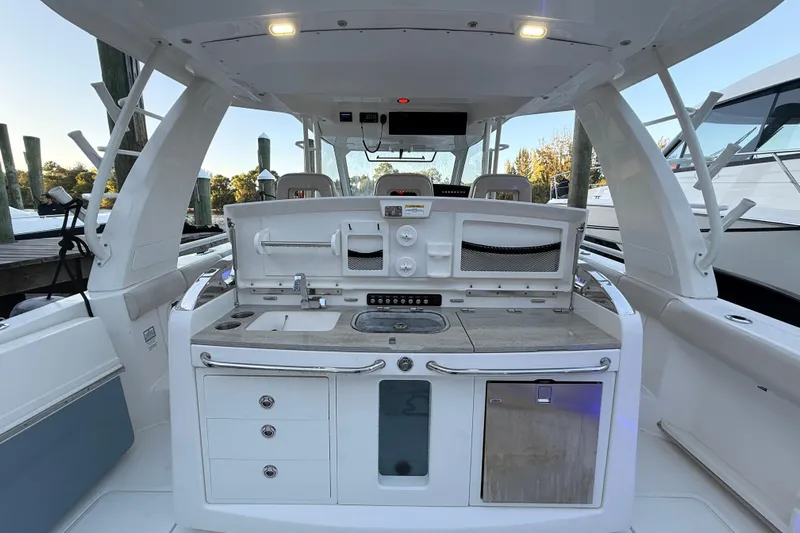  Yacht Photos Pics 2020 Boston Whaler 420 Outrage boat interior with kitchenette and storage.