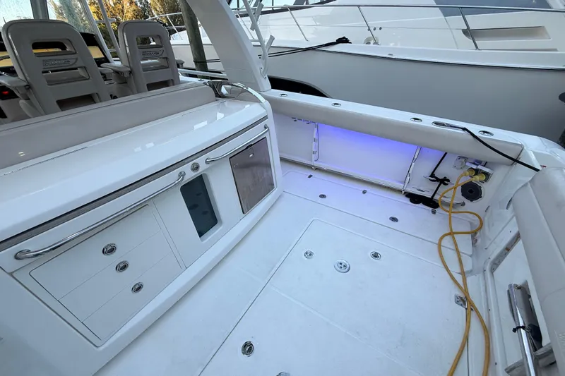  Yacht Photos Pics 2020 Boston Whaler 420 Outrage boat interior with seating and storage compartments.