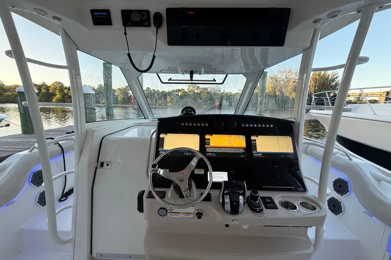  Yacht Photos Pics Cockpit of 2020 Boston Whaler 420 Outrage with advanced navigation systems and steering wheel.