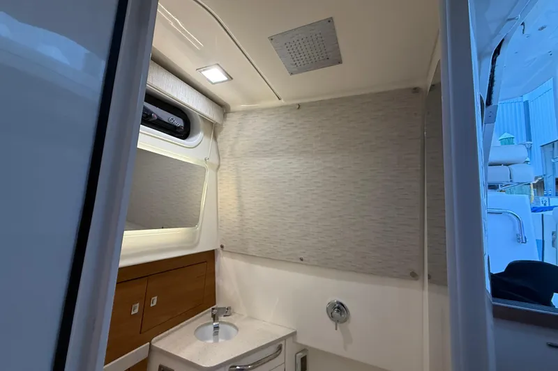  Yacht Photos Pics Interior of 2020 Boston Whaler 420 Outrage boat bathroom with sink and window.