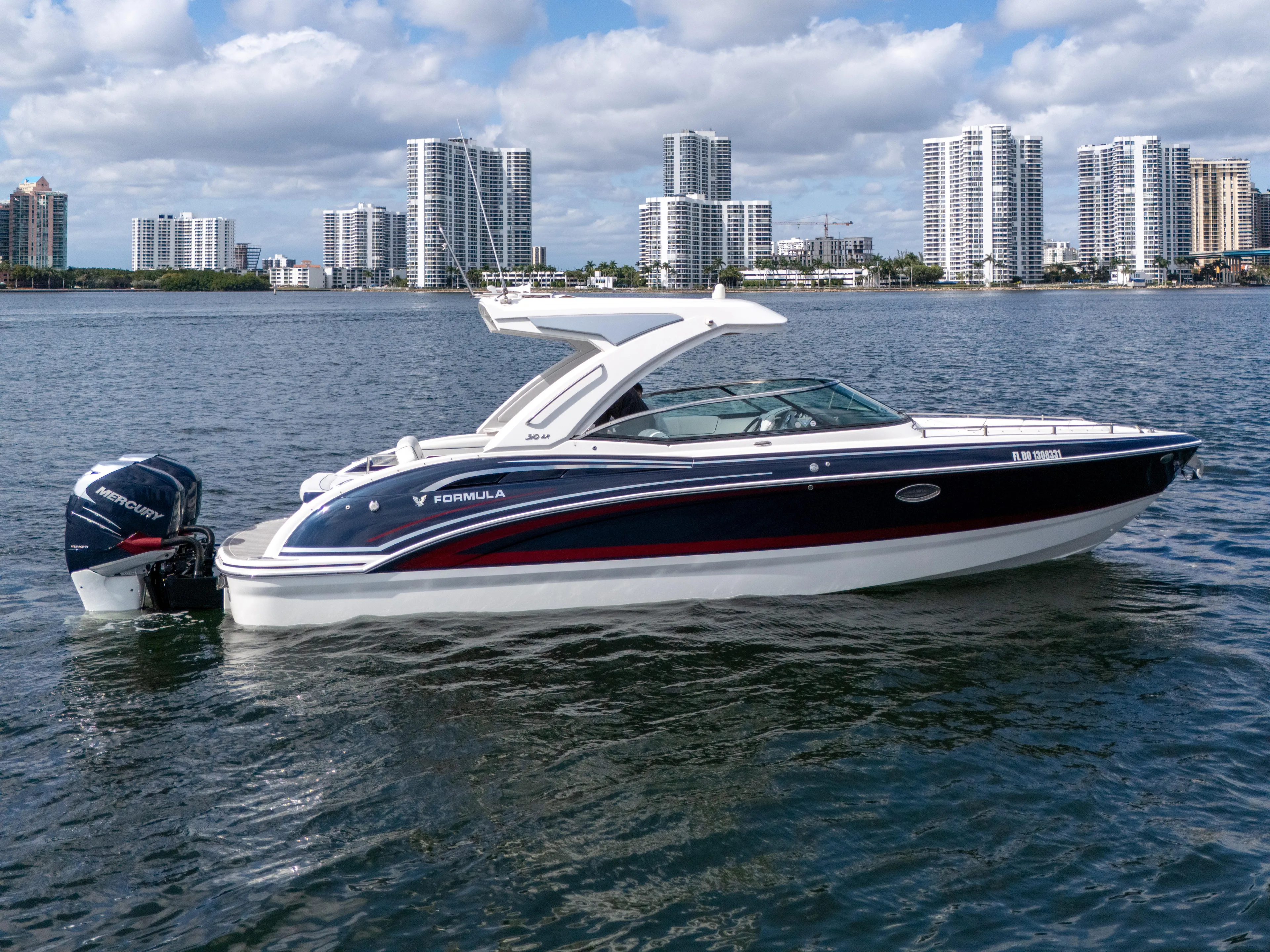 Without A Kaire Yacht Photos Pics 2020 Formula 310 Bowrider boat on water with city skyline background.