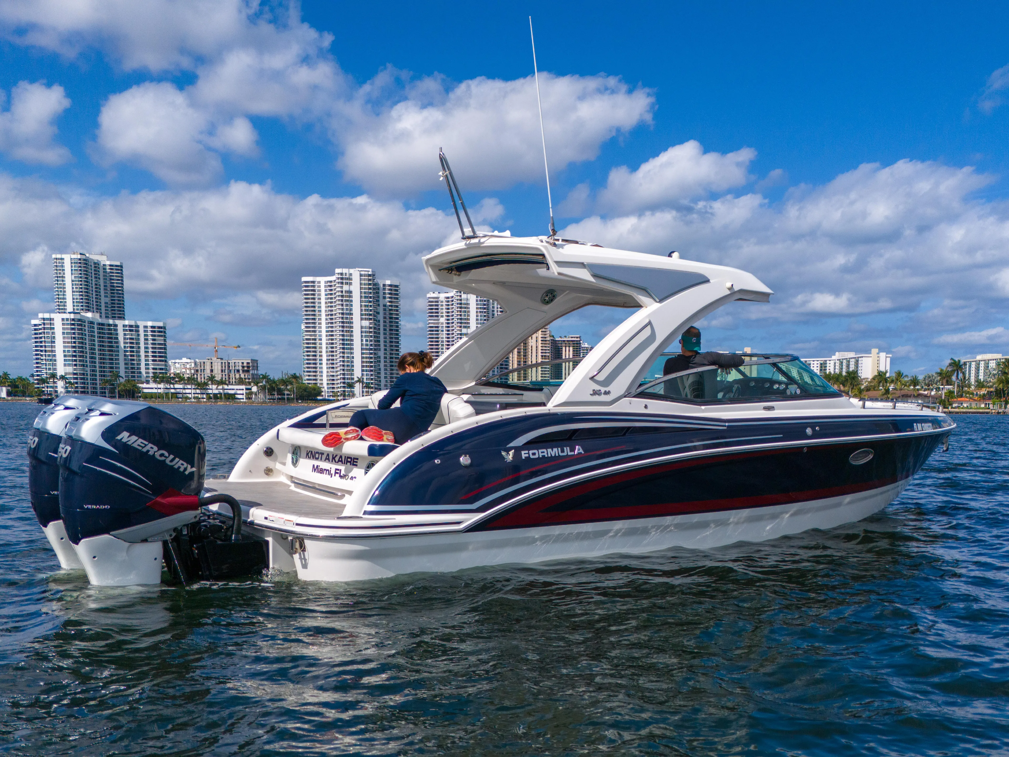 Without A Kaire Yacht Photos Pics 2020 Formula 310 Bowrider on water with city skyline in background.