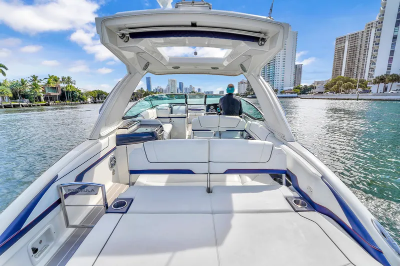 Without A Kaire Yacht Photos Pics 2020 Formula 310 Bowrider cruising on a scenic waterway with city skyline views.