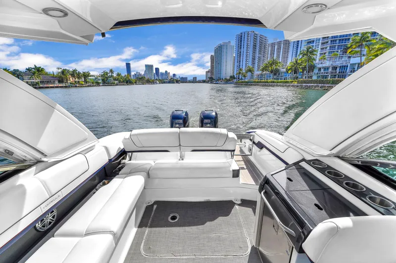 Without A Kaire Yacht Photos Pics 2020 Formula 310 Bowrider on scenic waterfront with city skyline and luxury seating.