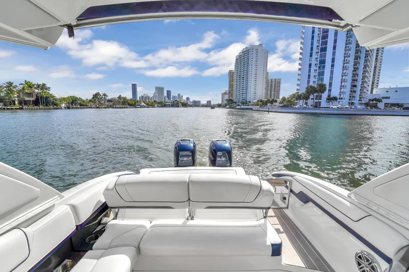 Without A Kaire Yacht Photos Pics 2020 Formula 310 Bowrider on water with city skyline in background.