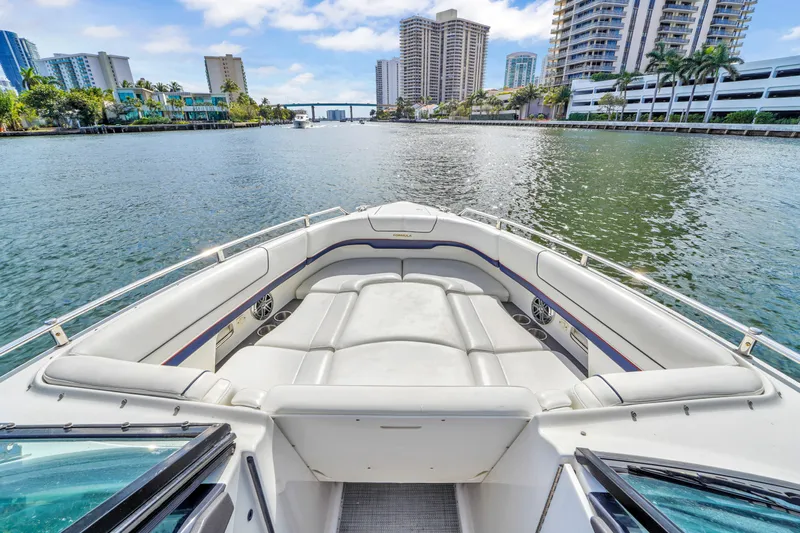 Without A Kaire Yacht Photos Pics 2020 Formula 310 Bowrider on a scenic waterway with city skyline.