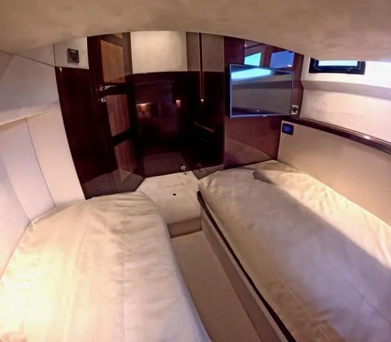 Docside Yacht Photos Pics Interior of 2021 Galeon 430 HTC yacht with twin beds and a wall-mounted TV.
