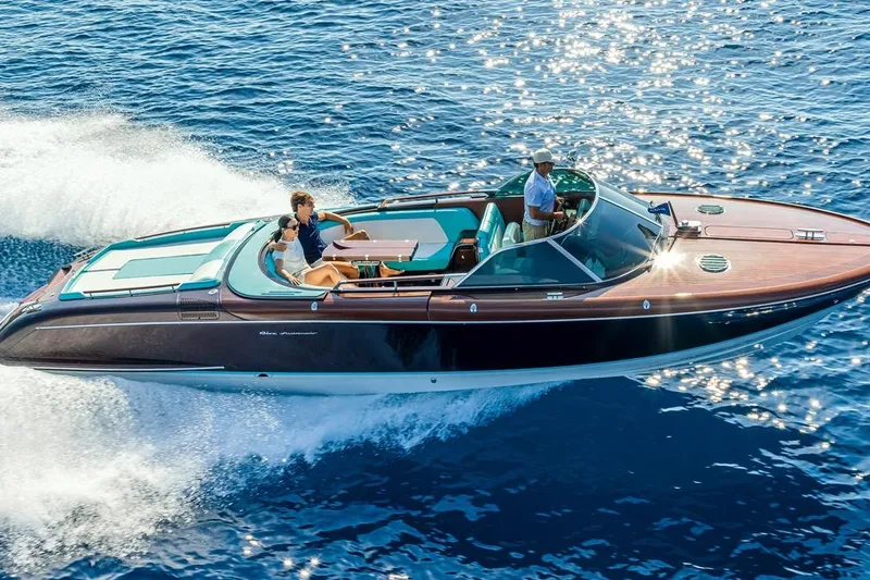Anniversario No. 7 Of 18 Yacht Photos Pics 2024 Riva Anniversario luxury boat cruising on sparkling blue water.