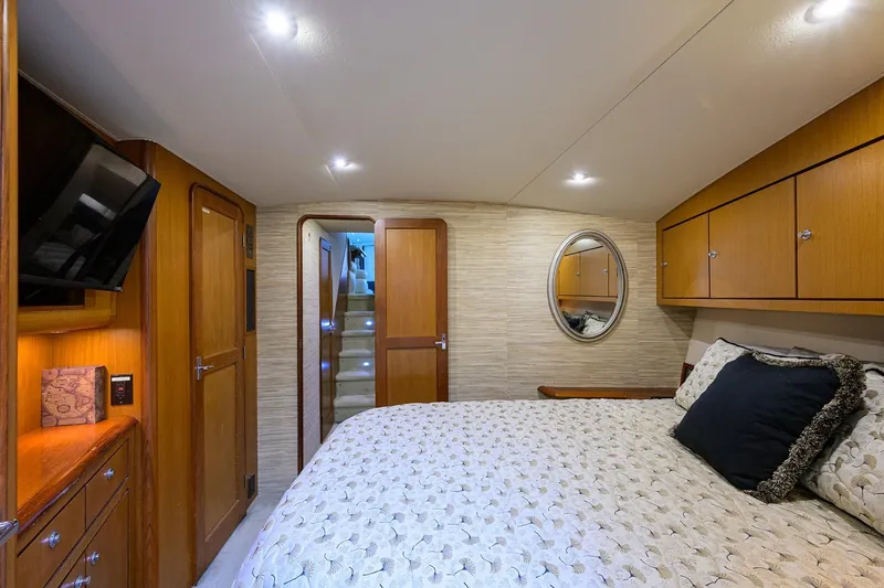 Members Only Yacht Photos Pics Luxurious 2001 Ocean Yachts Super Sport cabin interior with cozy bed and elegant wood finishes.